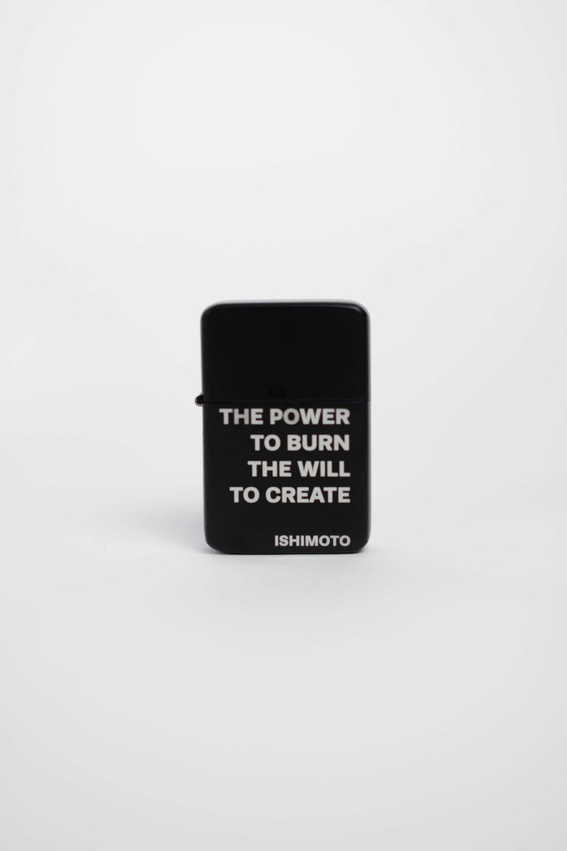 Black lighter engraved with "THE POWER TO BURN THE POWER TO CREATE"